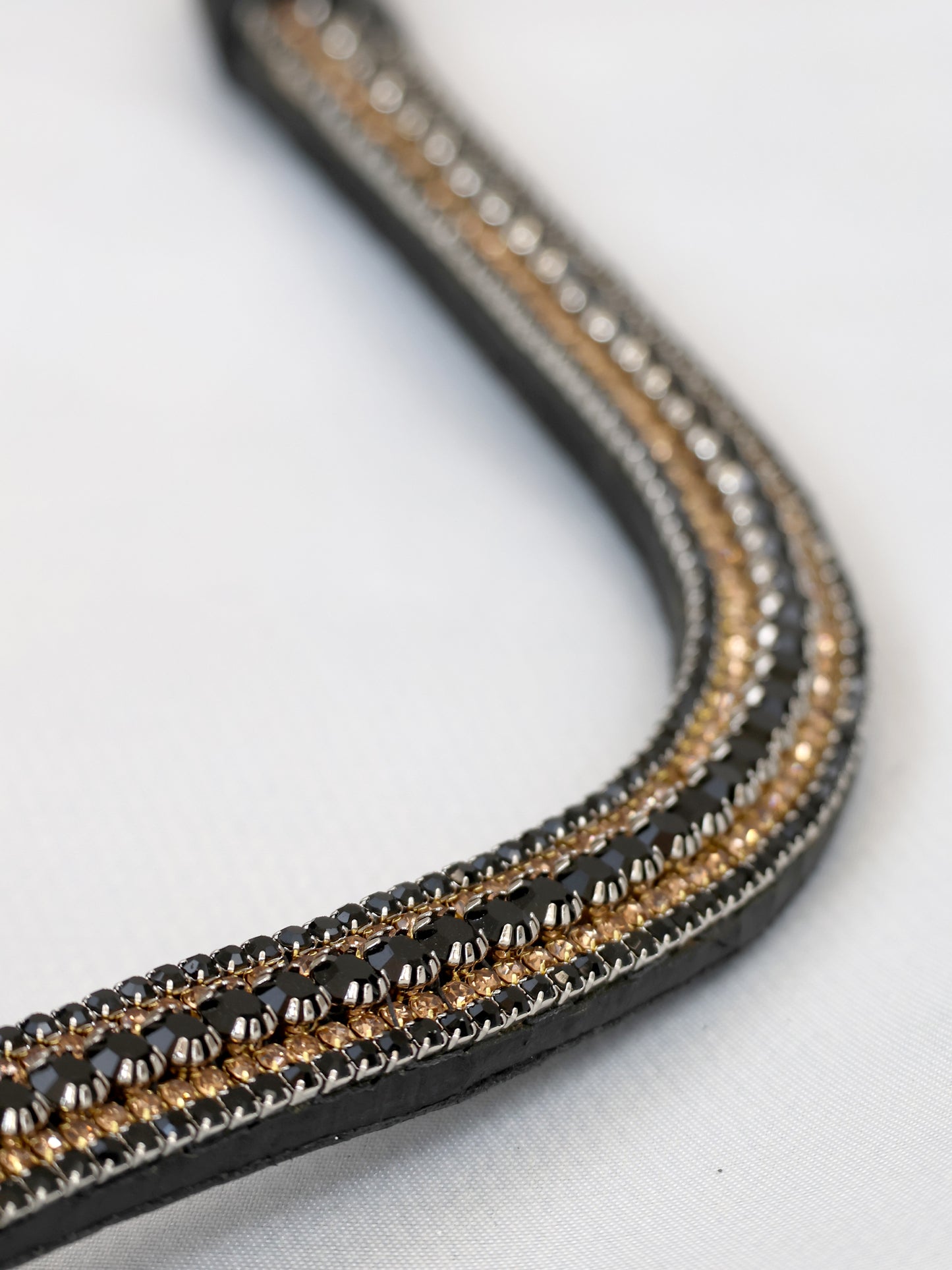 Black and gold crystal curved browband on black leather by Team Bloomfields, showing triple row black, gold and silver rhinestone detail, available in pony cob and full size