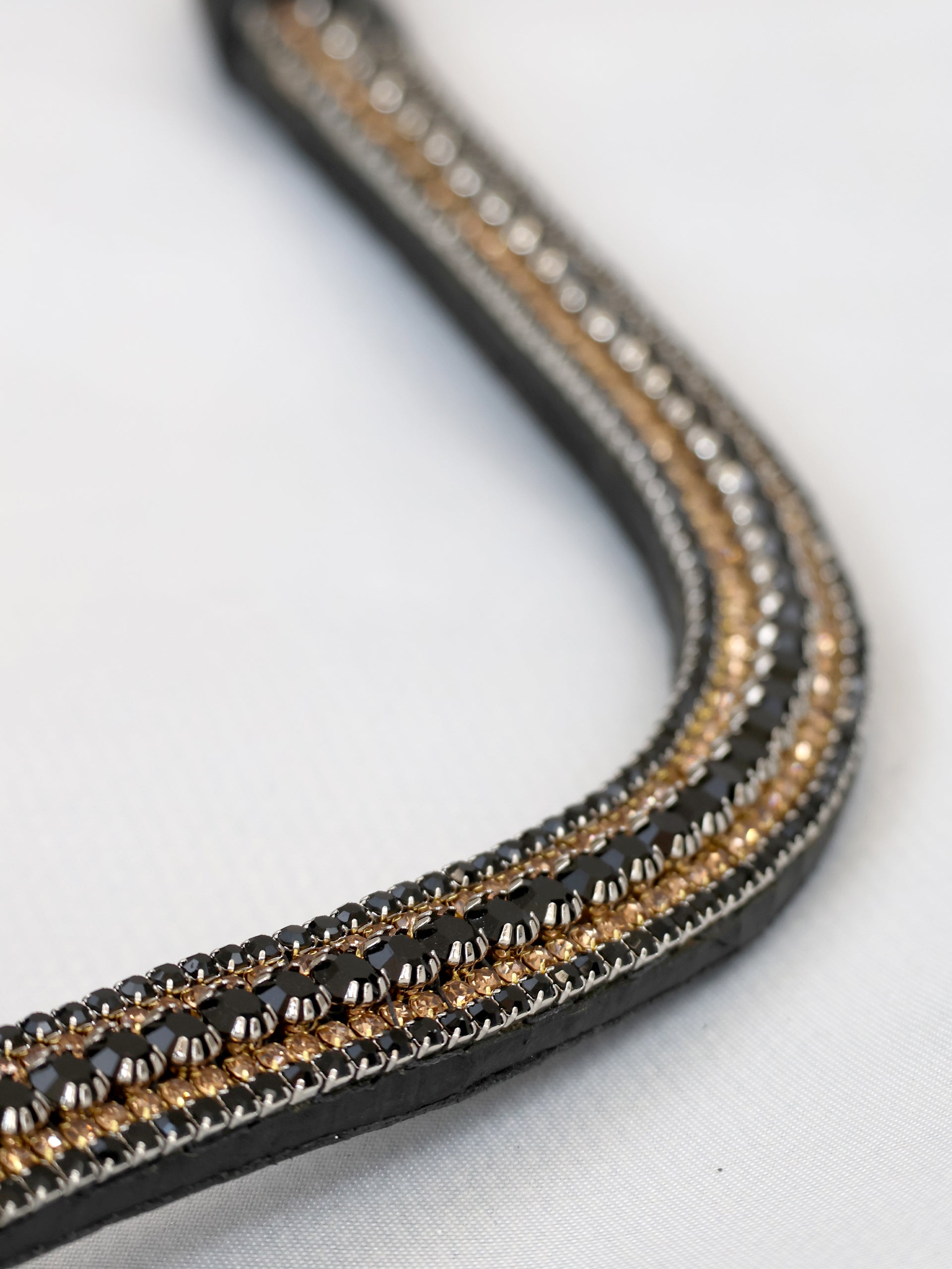 Black and gold crystal curved browband on black leather by Team Bloomfields, showing triple row black, gold and silver rhinestone detail, available in pony cob and full size