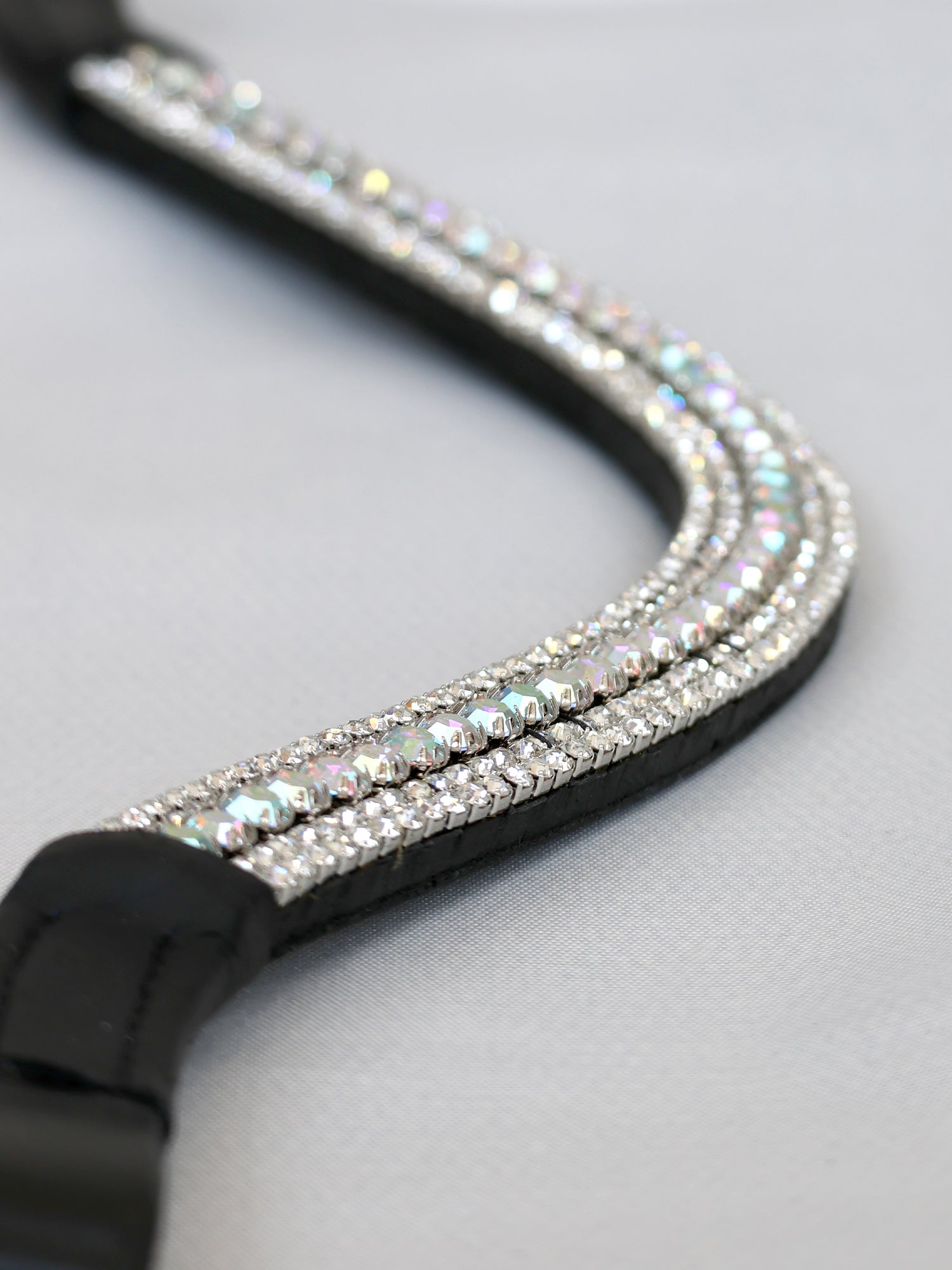 Silver and aurora crystal curved browband on black leather by Team Bloomfields, showing triple row rhinestone detail, available in pony cob and full size