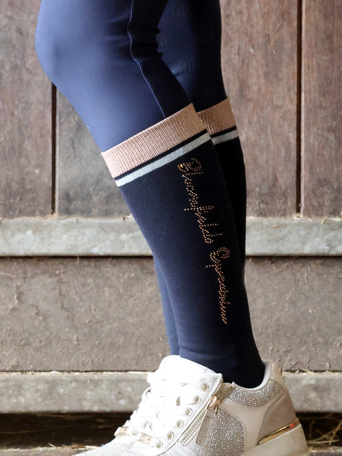 Trinity navy crystal knee high riding socks with rose gold rhinestone Team Bloomfields script and rose gold and silver striped band, available in S and L