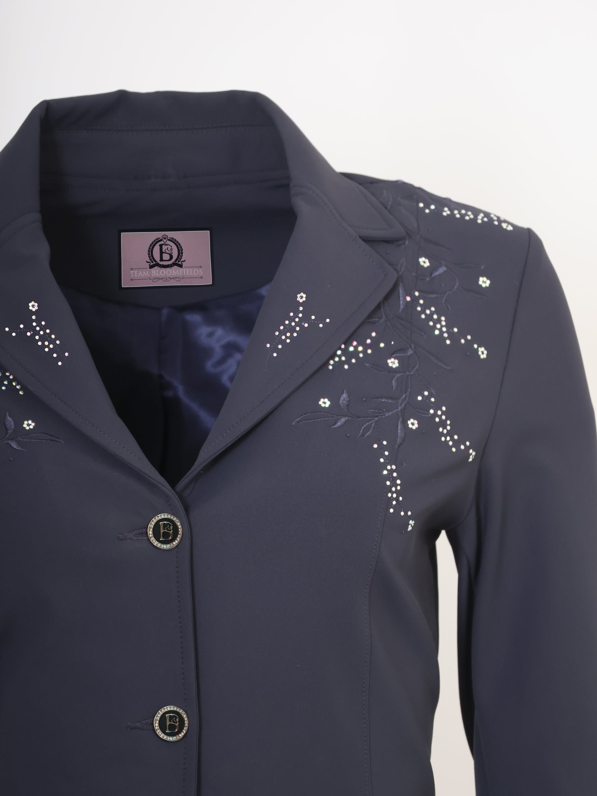 Close-up of embroidered floral vine and crystal embellishment detail on the Navy Vivienne Show Jacket